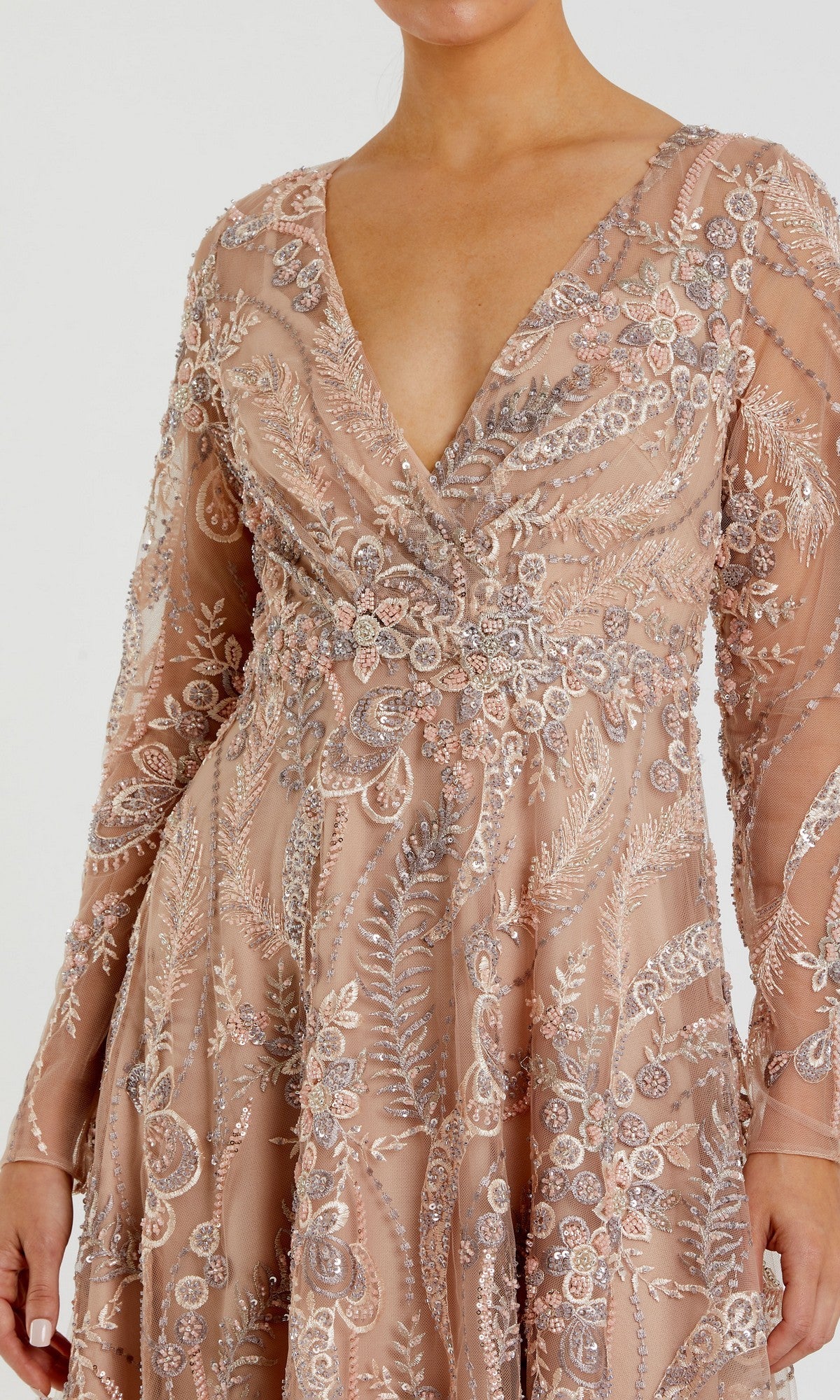 A person wearing the Mac Duggal 68906 Ankle-Length Party Dress, featuring long sleeves, a deep V-neckline, an elegant A-line skirt, and intricate silver and pink floral embroidery on blush pink fabric.